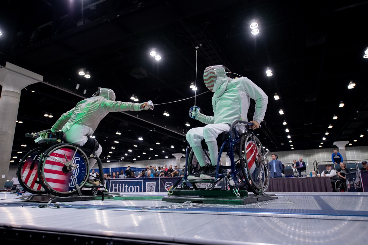 Wheelchair parafencing athletes in a bout
